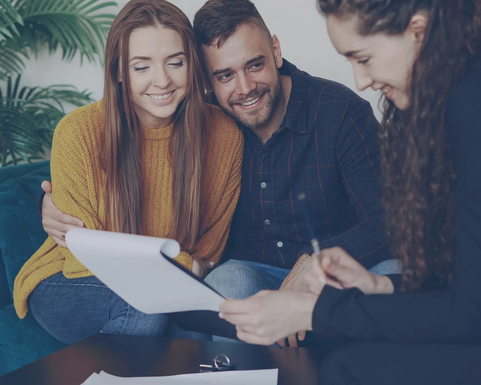 Financial advisor reviewing a plan with a couple in a relaxed office setting